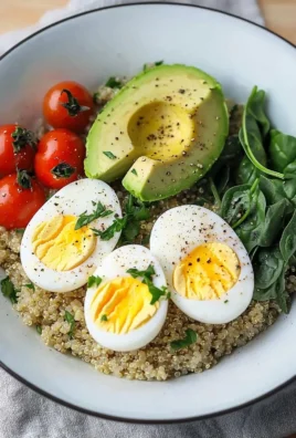 Savory quinoa breakfast bowl topped with vegetables and herbs
