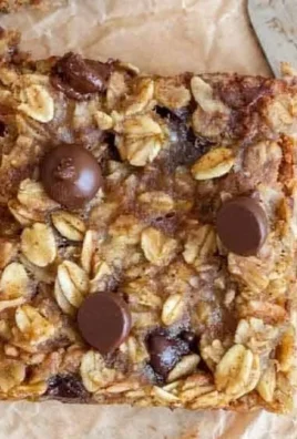 Delicious banana oatmeal bars on a wooden table, healthy snack option.