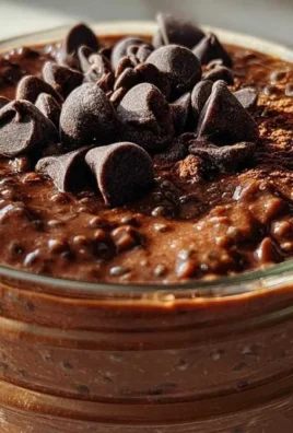 Delicious bowl of brownie batter overnight oats topped with chocolate and nuts