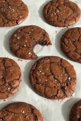 Delicious brownie cookies stacked on a plate, showcasing their rich chocolate texture.