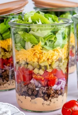 Cheeseburger Salad-in-a-Jar showcasing layers of ingredients in a clear jar.