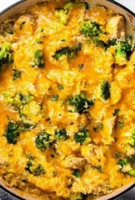 Cheesy Chicken and Rice Casserole in a baking dish, garnished with herbs.