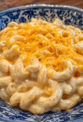 Creamy Chick-fil-A style mac and cheese topped with cheese on a plate.