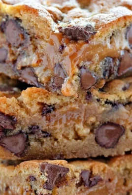 Delicious Chocolate Chip Caramel Bars topped with melted chocolate and caramel drizzle.
