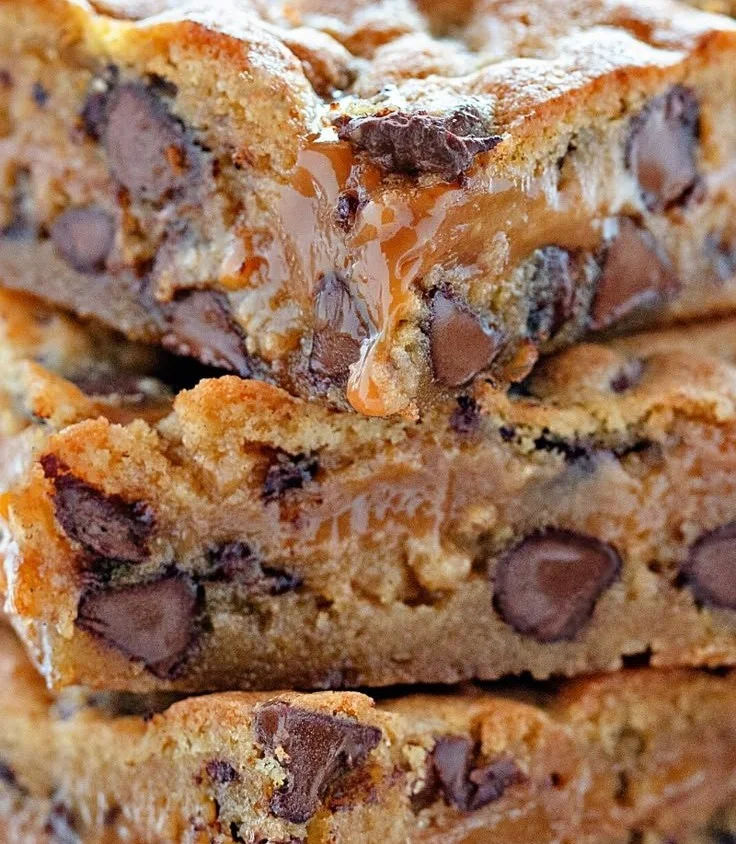 Delicious Chocolate Chip Caramel Bars topped with melted chocolate and caramel drizzle.