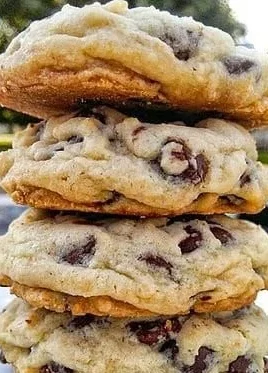 Freshly baked chocolate chip cookies on a cooling rack