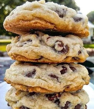 Freshly baked chocolate chip cookies on a cooling rack