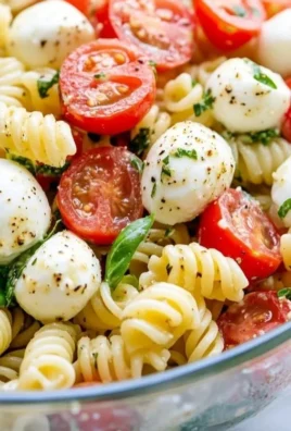 Creamy Caprese Pasta Salad with fresh tomatoes, mozzarella, and basil