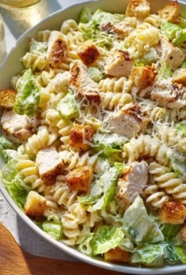 Creamy chicken pasta dish with vegetables and herbs served in a bowl