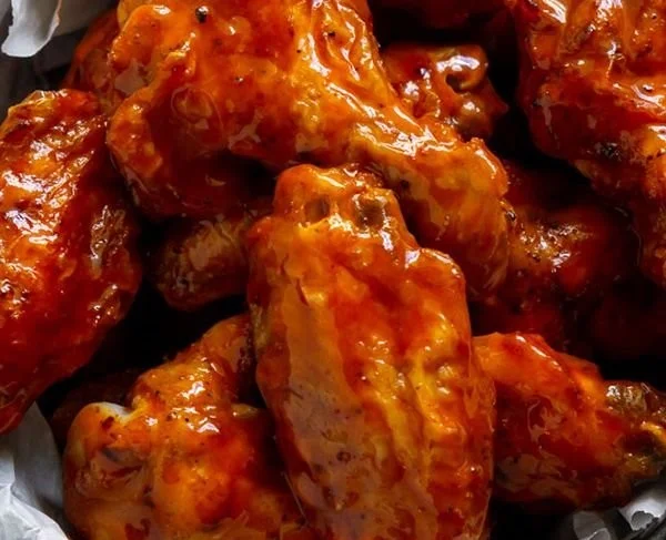 Crispy air fryer buffalo wings served with dipping sauce and celery sticks