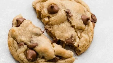 Delicious Crumbl chocolate chip cookies stacked on a plate