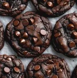 Delicious double chocolate chip cookies stacked on a plate