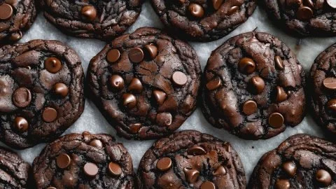 Delicious double chocolate chip cookies stacked on a plate