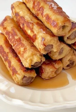 Delicious French Toast Roll-Ups served on a plate with syrup