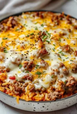 Ground Sausage and Rice Skillet served in a cast iron pan with colorful vegetables