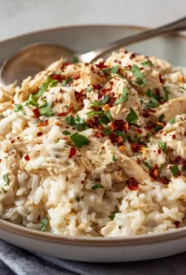 Bowl of Instant Pot creamy chicken and rice with herbs and spices
