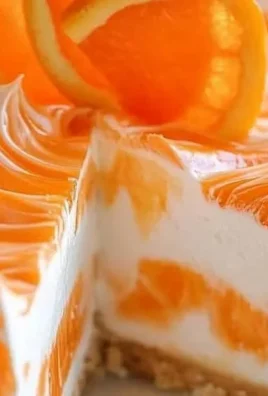 Slice of no-bake orange creamsicle cheesecake on a plate