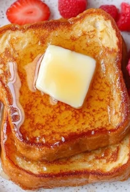 Perfectly cooked vanilla french toast served with syrup and berries