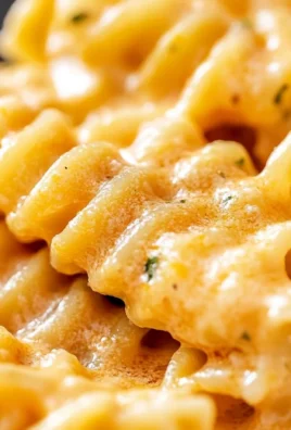 Creamy sauce with radiator pasta garnished with herbs