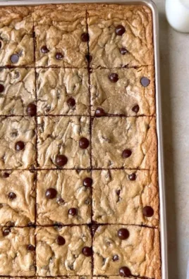 Delicious sheet pan chocolate chip cookies cooling on a wire rack
