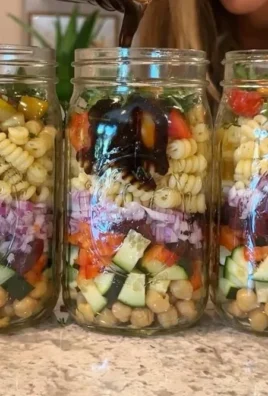 Bowl of colorful super-easy vegan pasta salad with fresh vegetables and herbs.