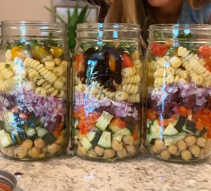 Bowl of colorful super-easy vegan pasta salad with fresh vegetables and herbs.