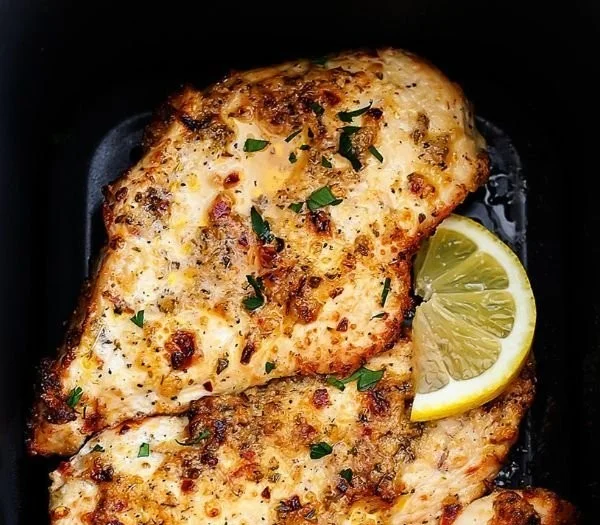 Delicious plate of Air Fryer Garlic Parmesan Chicken garnished with herbs