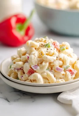 Bowl of creamy macaroni salad with vegetables and dressing