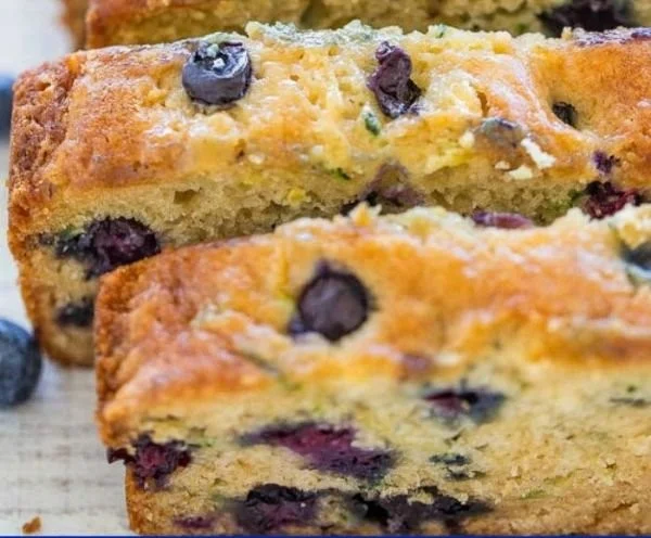 Freshly baked blueberry zucchini bread with blueberries and zucchini slices