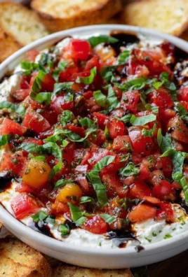 Delicious bruschetta dip served with crispy bread for a perfect party snack.