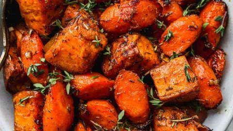 Deliciously roasted sweet potatoes and carrots served on a plate
