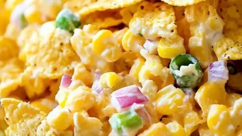 Colorful bowl of Frito Corn Salad featuring corn, Fritos, and fresh veggies