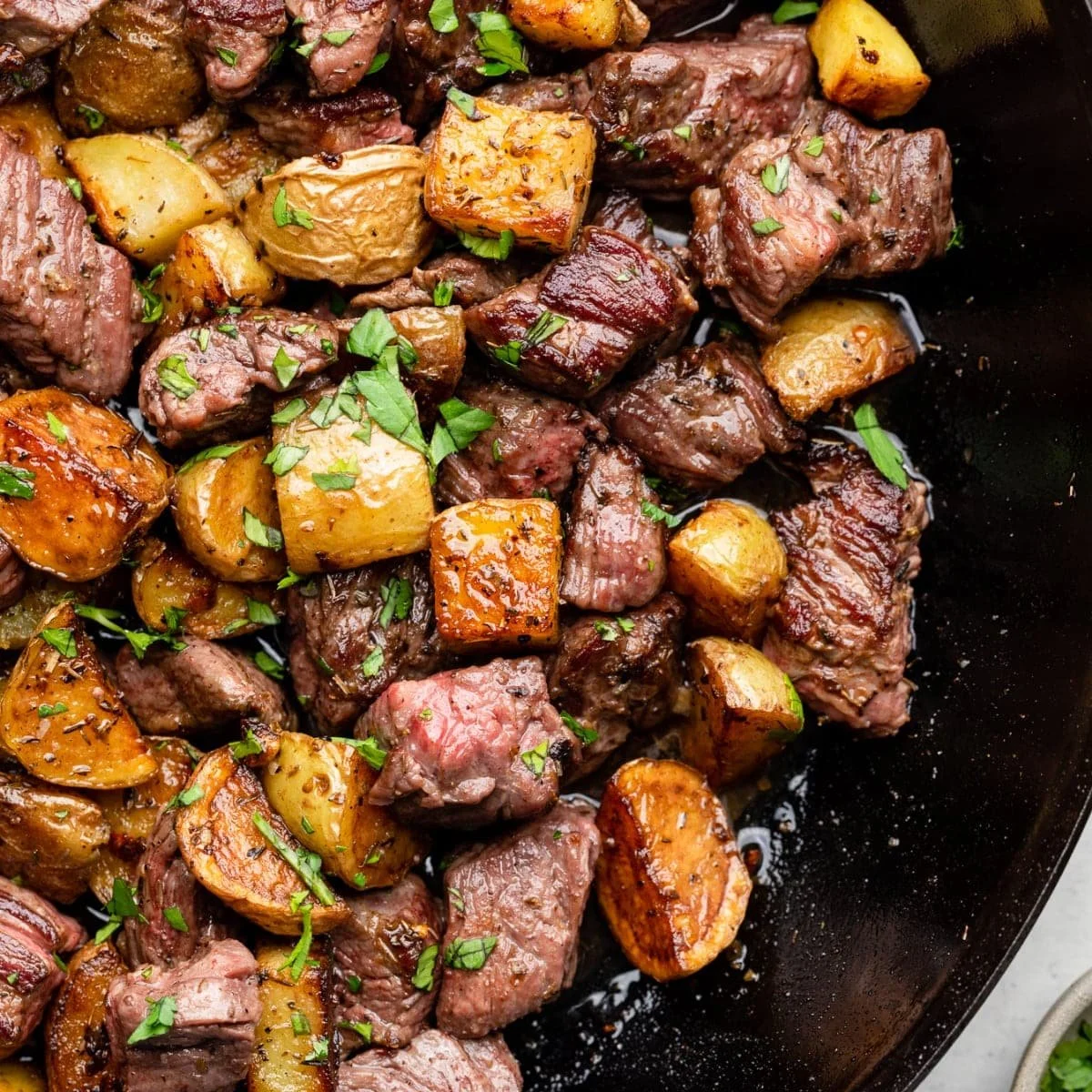 Delicious garlic butter steak bites served with golden potatoes
