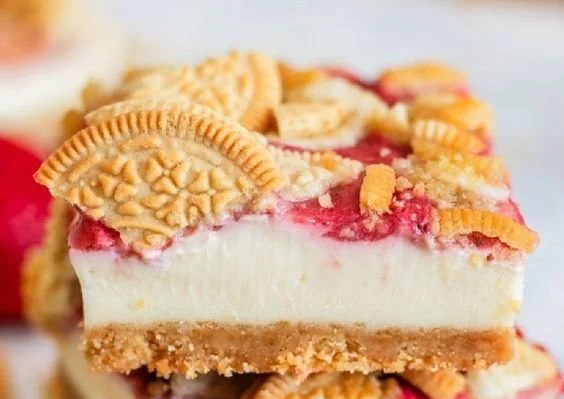 Golden Oreo Strawberry Cheesecake Bars topped with fresh strawberries.