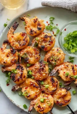 Juicy grilled Bang Bang Shrimp skewers served on a plate