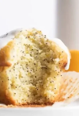 Freshly baked lemon poppy seed muffins on a cooling rack
