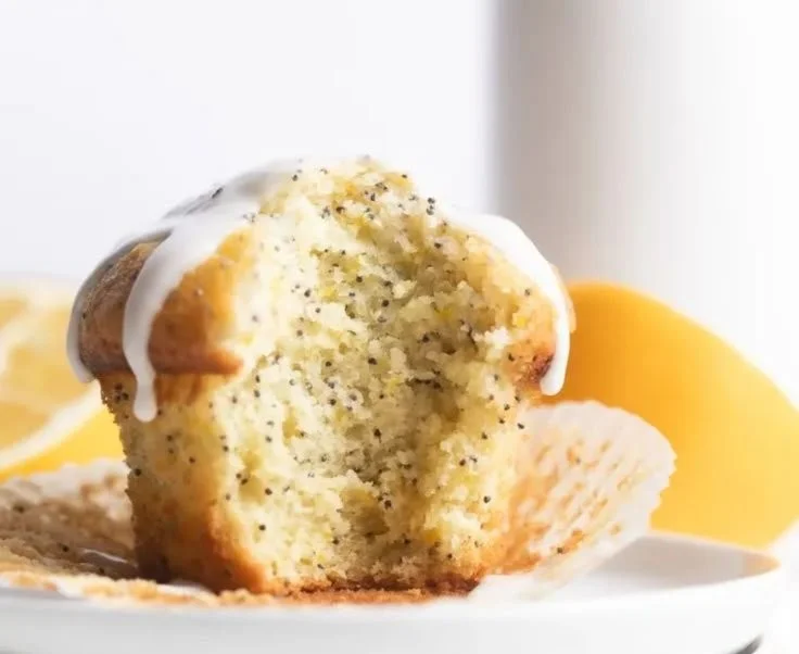 Freshly baked lemon poppy seed muffins on a cooling rack