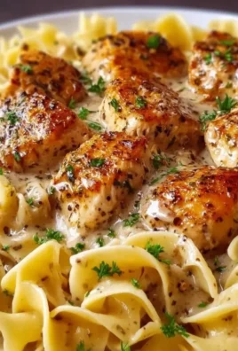Creamy garlic butter chicken served with egg noodles in a skillet