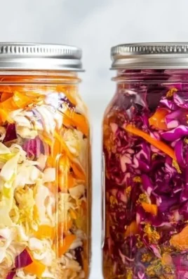 Homemade sauerkraut in a jar, showcasing vibrant cabbage and fermentation bubbles.
