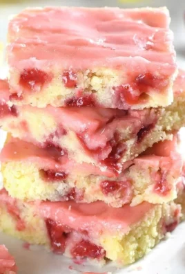 Delicious strawberry lemon blondies topped with fresh strawberries and lemon zest.