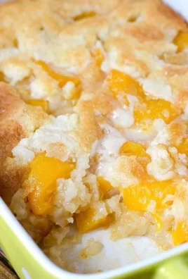 Delicious super easy peach cobbler served warm with ice cream