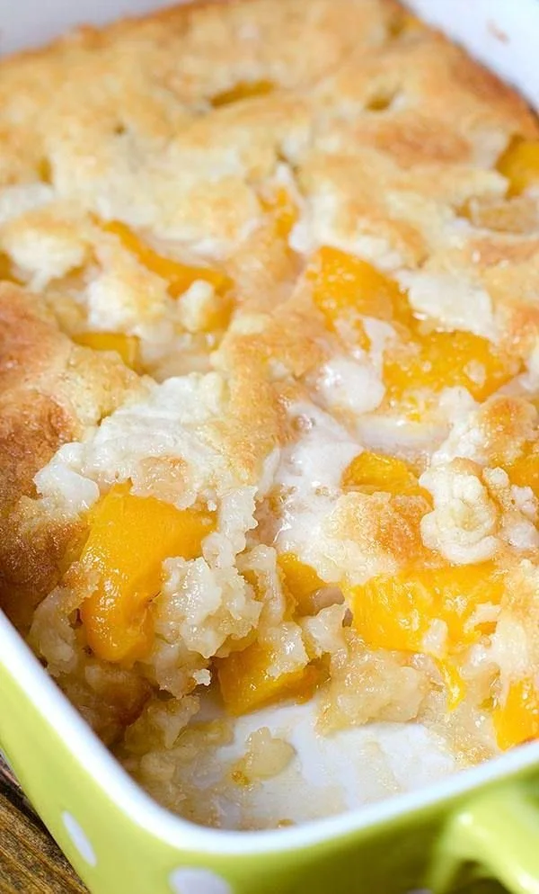 Delicious super easy peach cobbler served warm with ice cream