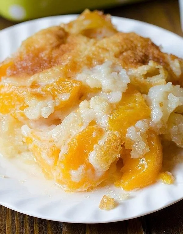 A delicious homemade peach cobbler served warm with a scoop of ice cream.
