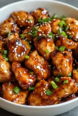 Delicious plate of sweet and spicy hot honey chicken garnished with herbs