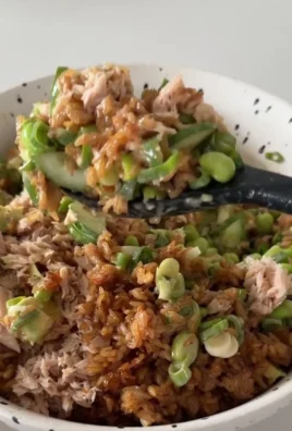Tuna Avocado Salad topped with crispy rice for a flavorful dish.